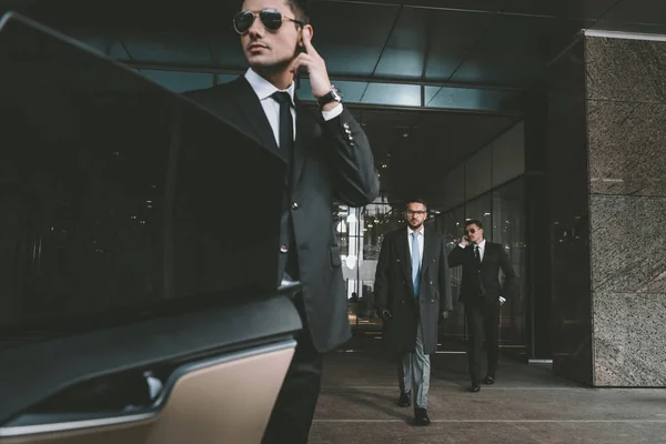 depositphotos_174776994-stock-photo-bodyguard-opening-car-door-businessman